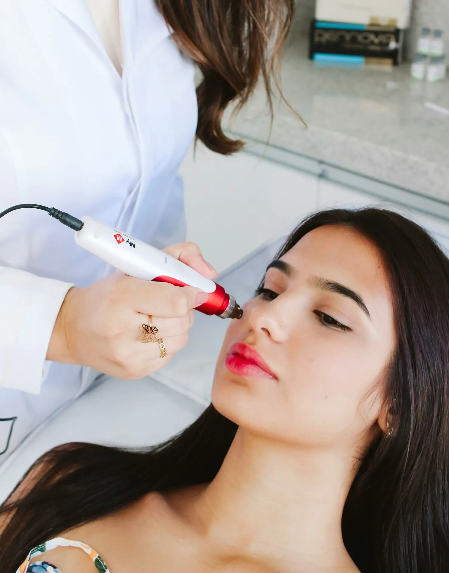 A woman getting her make - up done by a professional makeup artist