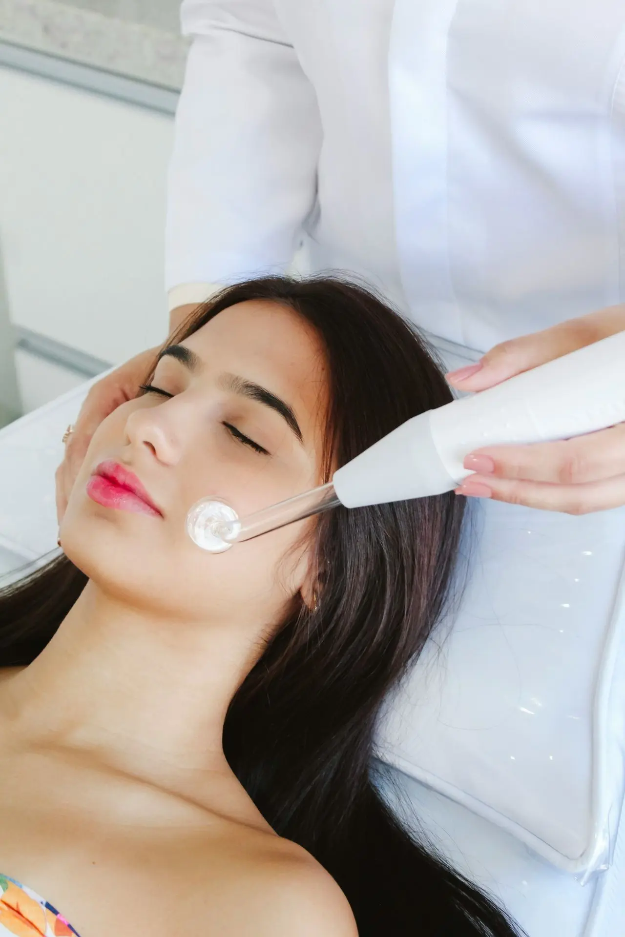 A woman getting her hair brushed by a hair stylist